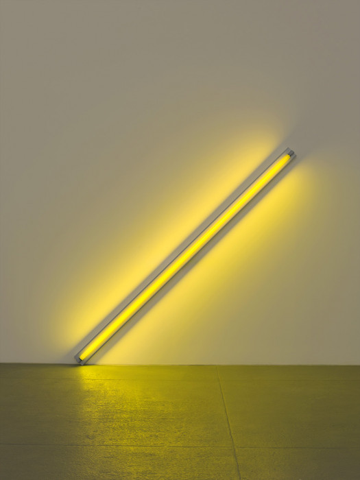 Fluorescent yellow light installed at a 45-degree angle to the right and with the left corner touching floor.
