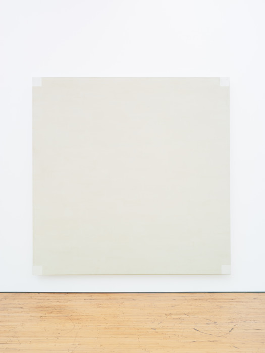 A square, light-gray painting includes four white squares in each corner.