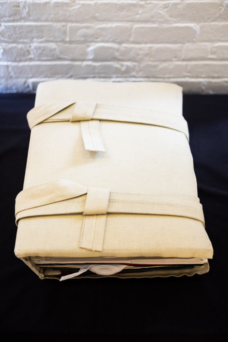 An object wrapped in beige fabric.