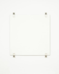 A white square hangs on a white wall using four exposed fasteners with bolts, two on the top and two on the bottom.