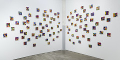 Mutliple multicolored small square artworks that read 