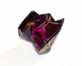 Angular crumpled metal object, painted sparkly purple with some small orange splotches.