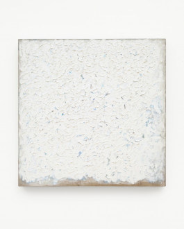 Square painting with thick, textured white paint with blue speckles showing through, on a tan canvas which is visible on the bottom edge.
