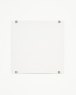 A white square hangs on a white wall using four gray bolts and fasteners, affixed to the bottom and top of the work and near the corners.
