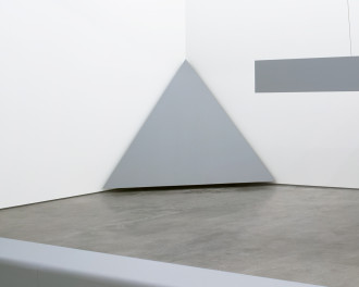A large, gray, equilateral triangle is placed in a corner.