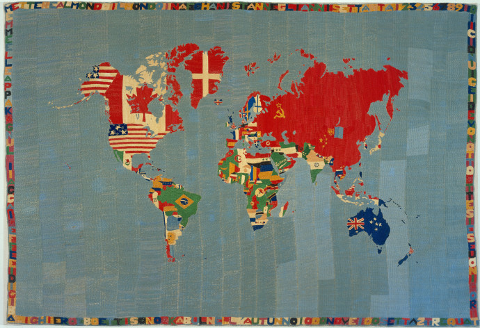 Rectangular map of the world with flags embroidered on their respective countries and a border of letters and numbers.
